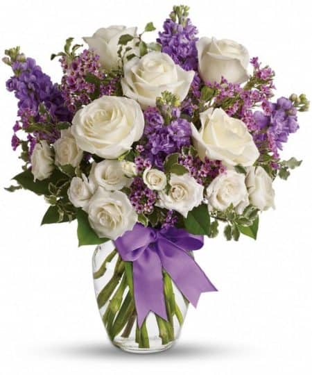 White roses and lavender stock in a vase
